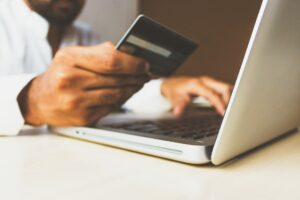 Person making a purchase on their laptop whilst holding a credit card