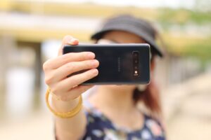 Someone holding their phone filming a TikTok ads video