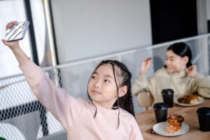 Children taking a selfie at a cafe as an example of UGC